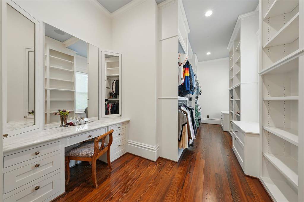 A boutique-inspired primary closet designed for effortless elegance. With extensive hanging space, custom drawers, built-in shelving, and a dedicated dressing area, this walk-in sanctuary combines style, organization, and functionality in one beautifully tailored space.