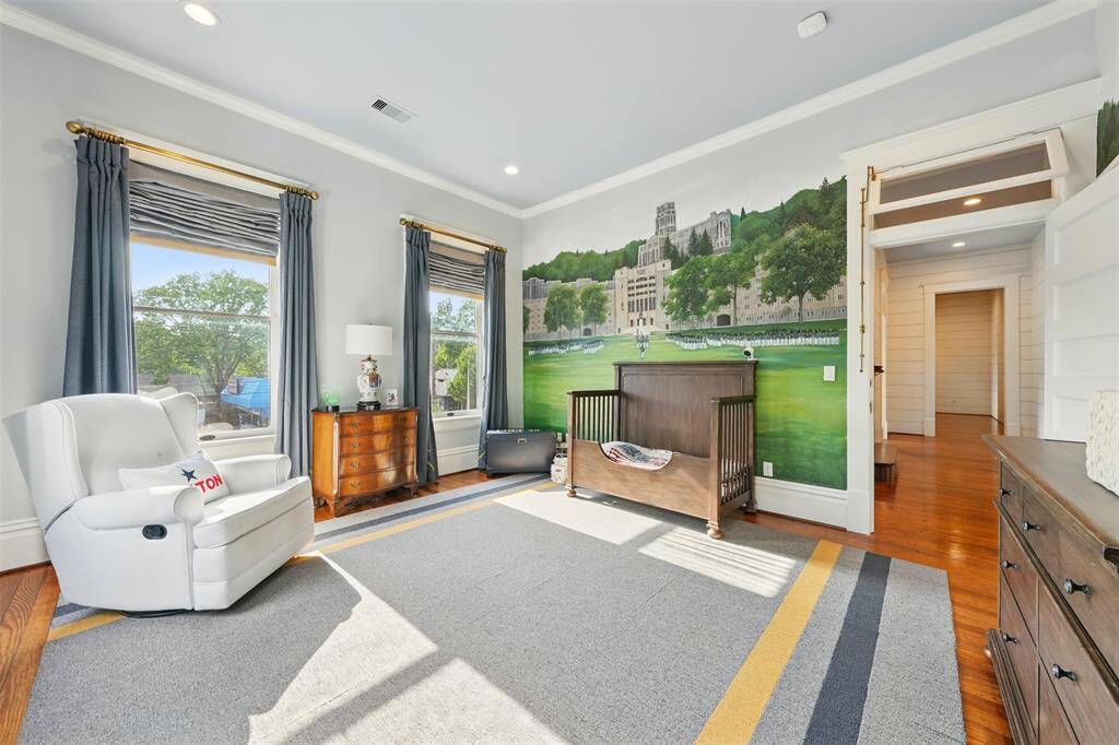 A bold, character-filled space with a nod to tradition. This spacious bedroom is elevated by a custom mural of West Point’s iconic campus, adding both narrative and visual impact. Original floors and wide baseboards are complemented by tall ceilings, oversized windows, and flexible layout options.