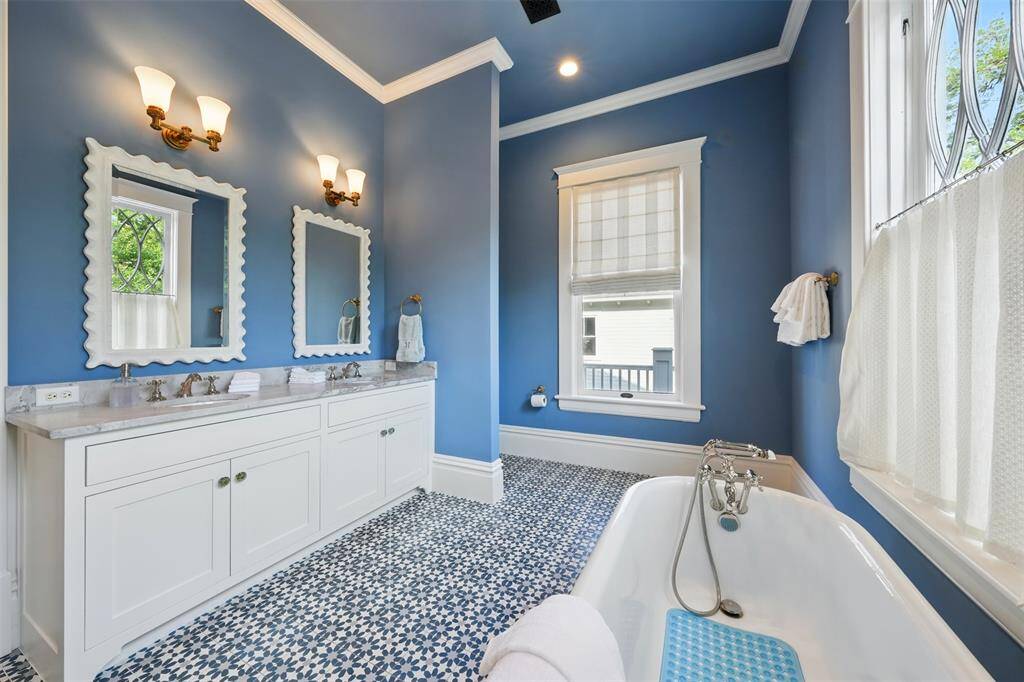 Refined, spacious, and highly functional. This vibrant bathroom features a double vanity topped with leathered Dolomite, offering both striking texture and durability. Generous shower dimensions add unexpected spaciousness, elevating the room’s comfort and everyday luxury.
