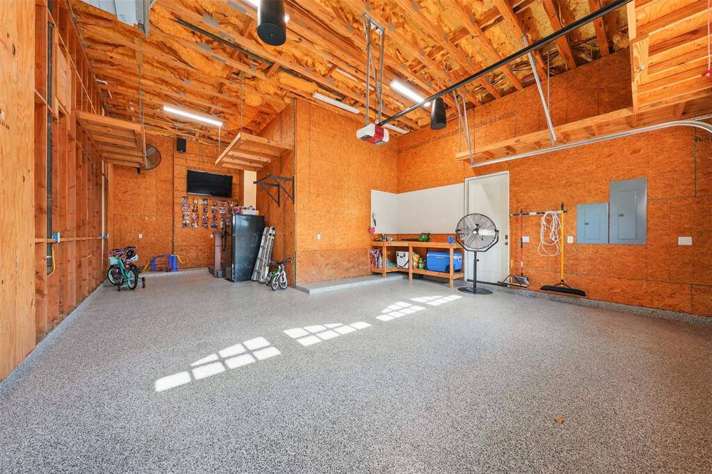 This spacious three-car tandem garage offers exceptional versatility, with room for a workshop, bike storage, or a deep freezer. Built-in overhead storage maximizes functionality, with potential to expand. The epoxy-coated floor ensures durability and easy maintenance—ideal for both everyday use and specialized needs.