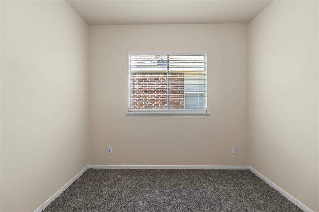 You’ve got a flexible space ready to become whatever you need—an inspiring workspace, a peaceful reading spot, or another bedroom. Natural light from the window adds a warm, inviting feel that makes it easy to make the space your own.