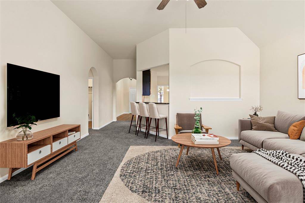 Spacious and inviting, your living area sets the stage for everything from quiet evenings to lively get-togethers. High ceilings, soft carpet, and elegant arched walkways create an open flow into the kitchen and surrounding spaces—making it easy to settle in and feel right at home.