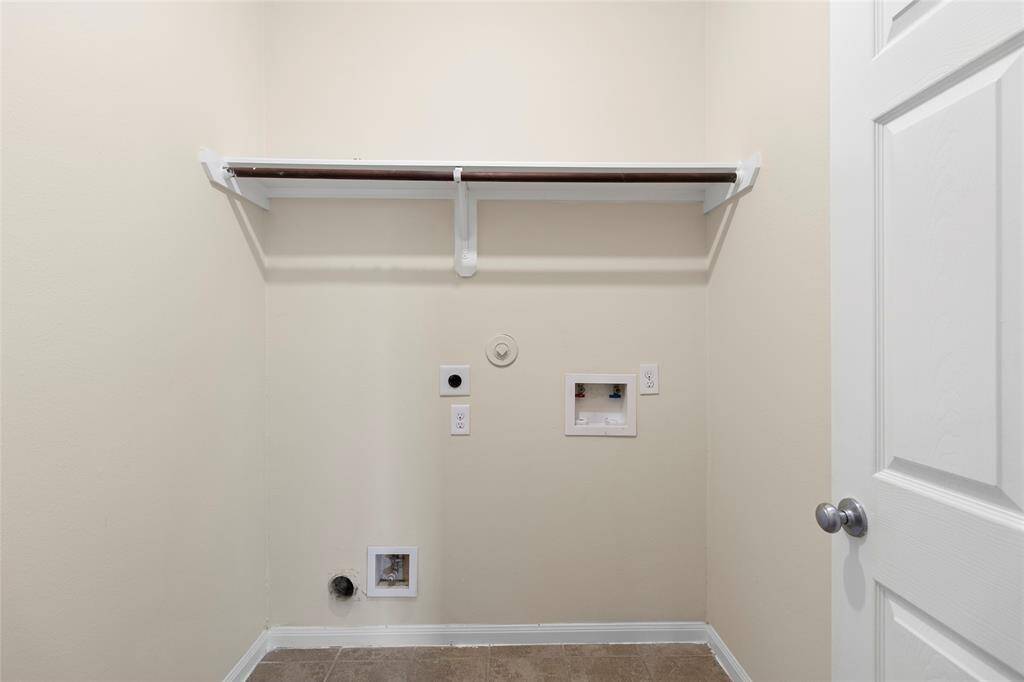 Your laundry space is tucked away for convenience and features upper shelving—perfect for keeping your detergents, baskets, and laundry essentials organized and within easy reach.