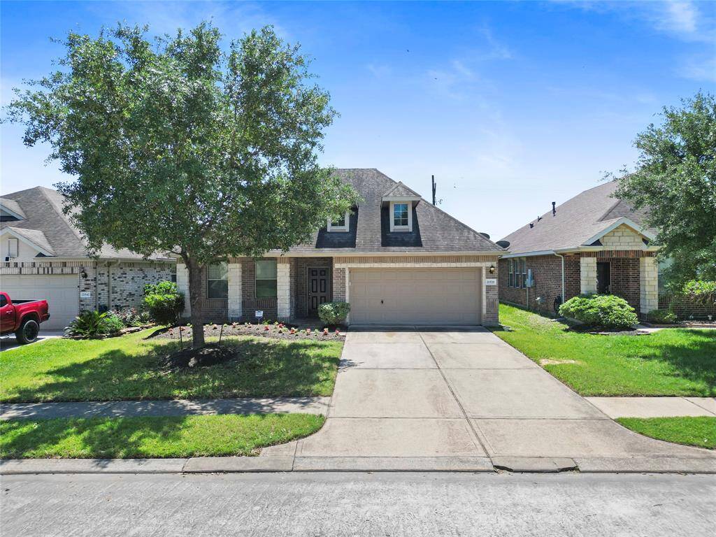 From the moment you pull into the driveway, you’re greeted by a beautifully shaded front yard and a charming brick exterior that sets the tone for what’s inside—comfortable, spacious living with curb appeal that feels truly yours.