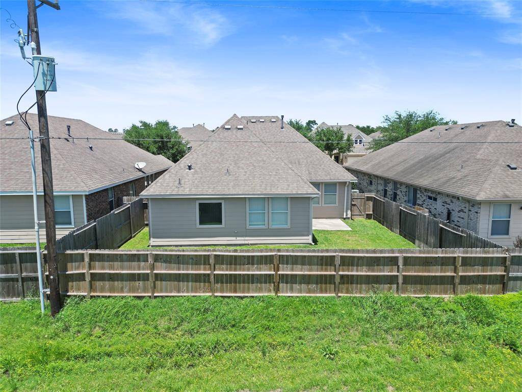 Your backyard offers a fully fenced space with a small patio—ideal for grilling out, letting pets roam freely, or enjoying quiet outdoor moments with added privacy.