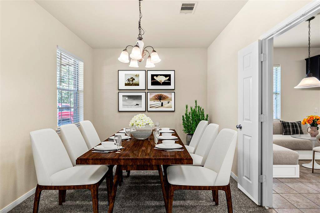 Just off the entryway, this flexible space offers the perfect spot for a formal dining area, home office, or reading room. A large window brings in natural light, while the neutral tones and cozy carpet make it easy to tailor the space to your needs.