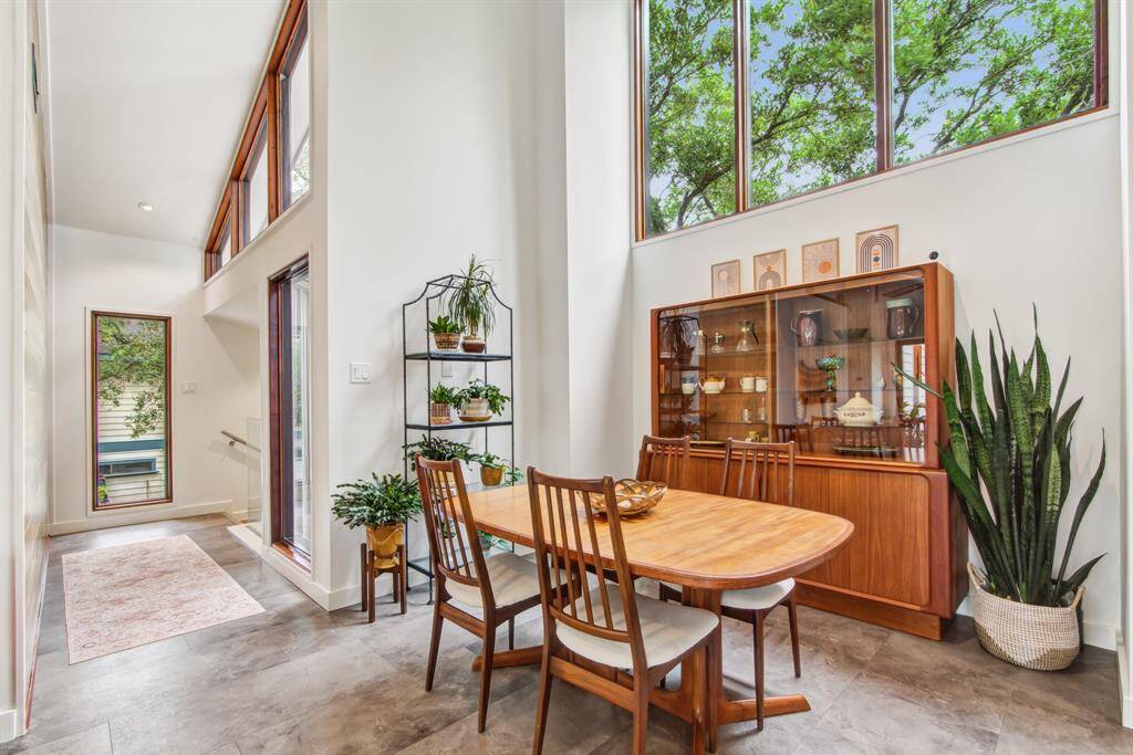 Vaulted ceilings and large windows add to the open and airy feel of this dining space.
