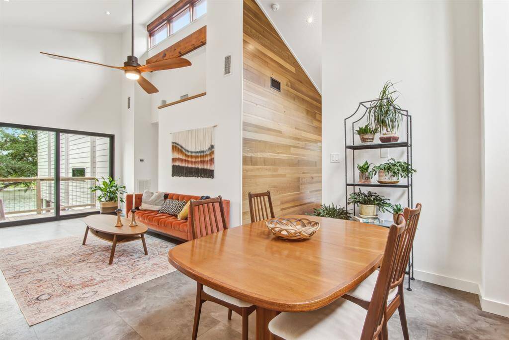 English oak feature wall reclaimed from the Houston Chronicle building adds style and elegance to the entry into this dining and living space.