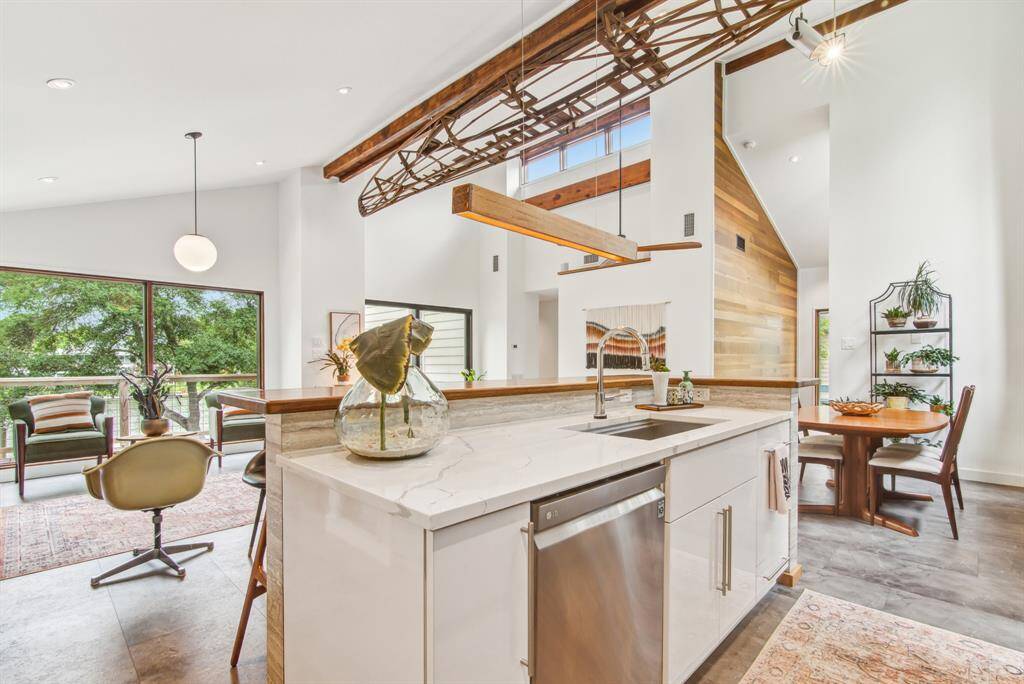 Quartz counter top with deep sink and LG dishwasher. Water views from the entire living space.