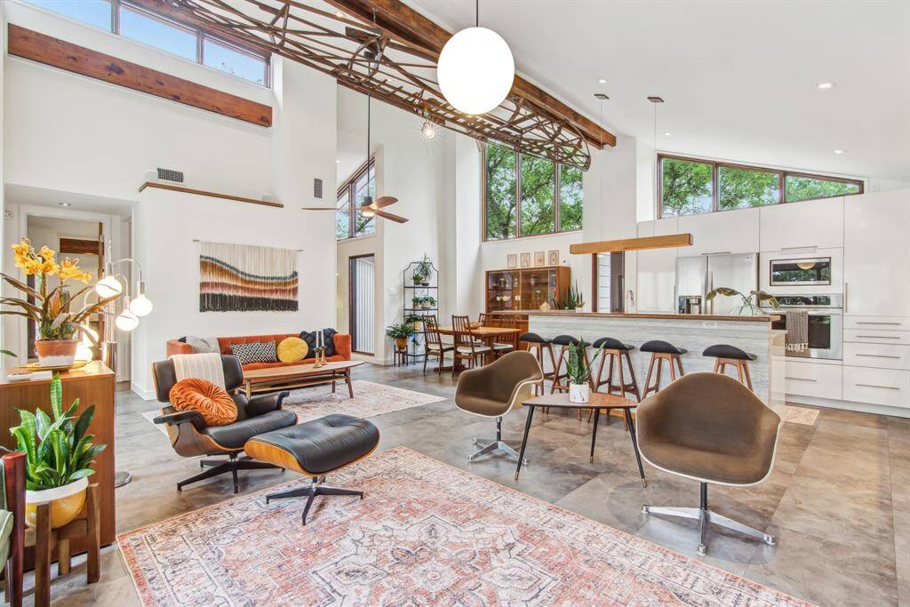 Spacious living area feels large and airy with vaulted ceiling and lots of natural light. Large windows placed high up to maximize light and privacy.