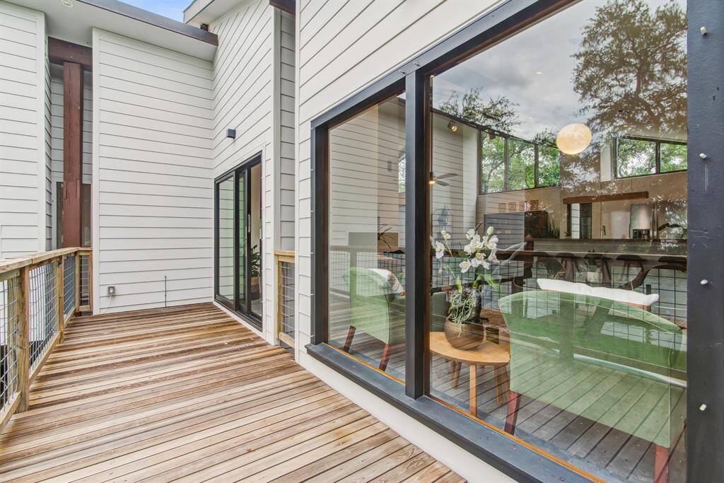 Large deck of living space with redwood decking. Hurricane sliding doors.