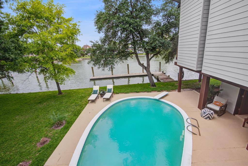 Stunning water view from the deck overlooking the private pool and boat slip. Enjoy this oversized and fenced yard.