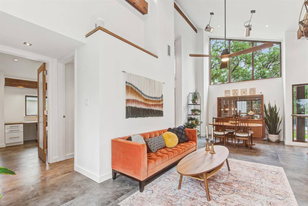 Luxury tile floor continues throughout the home into bedrooms from living space. View of the large picture windows giving lots of natural light along with privacy.