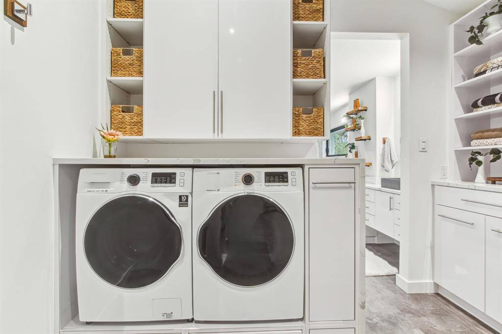 Samsung washer and dryer conveniently inside the primary walk in closet. additional built in storage cabinetry surround along with water fall quarts counter top.
