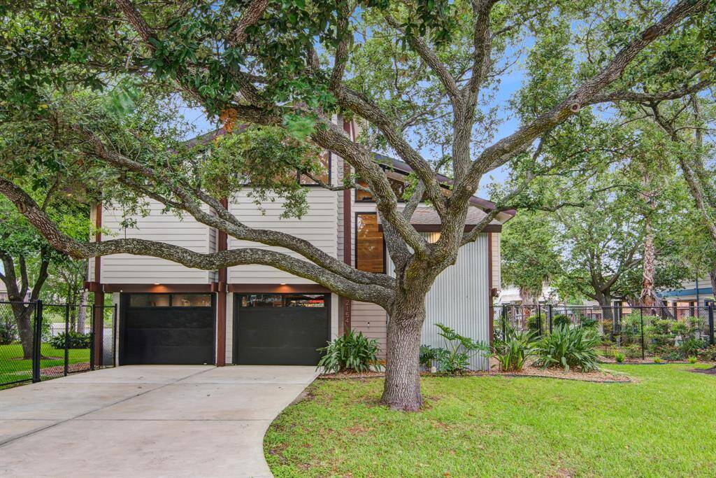 View of the front of this stunning home with two car garage and over sized couple lot.