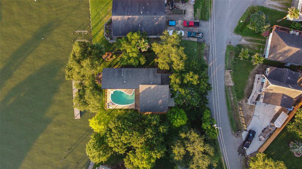 Aerial view of home with gorgeous pool and direct waterfront. 40' boat slip. Everything rebuilt from roof on down.