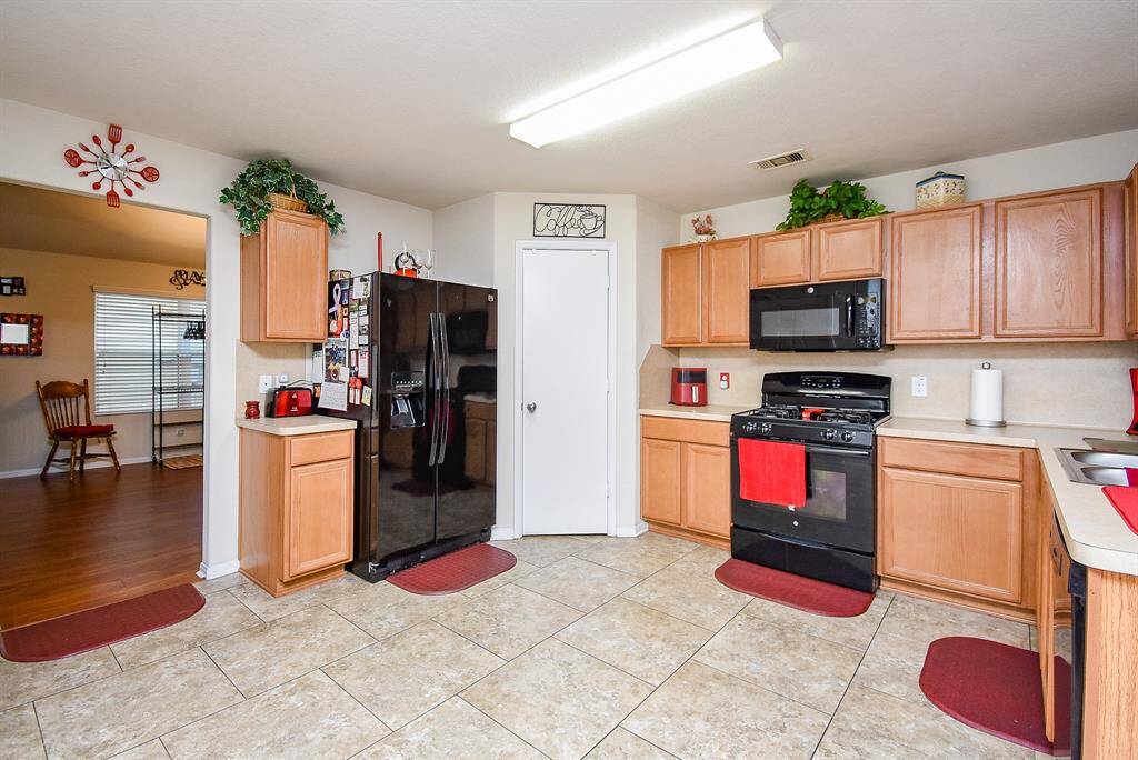 Living room flows into the large kitchen with generous cabinet storage, a pantry and counterspace.