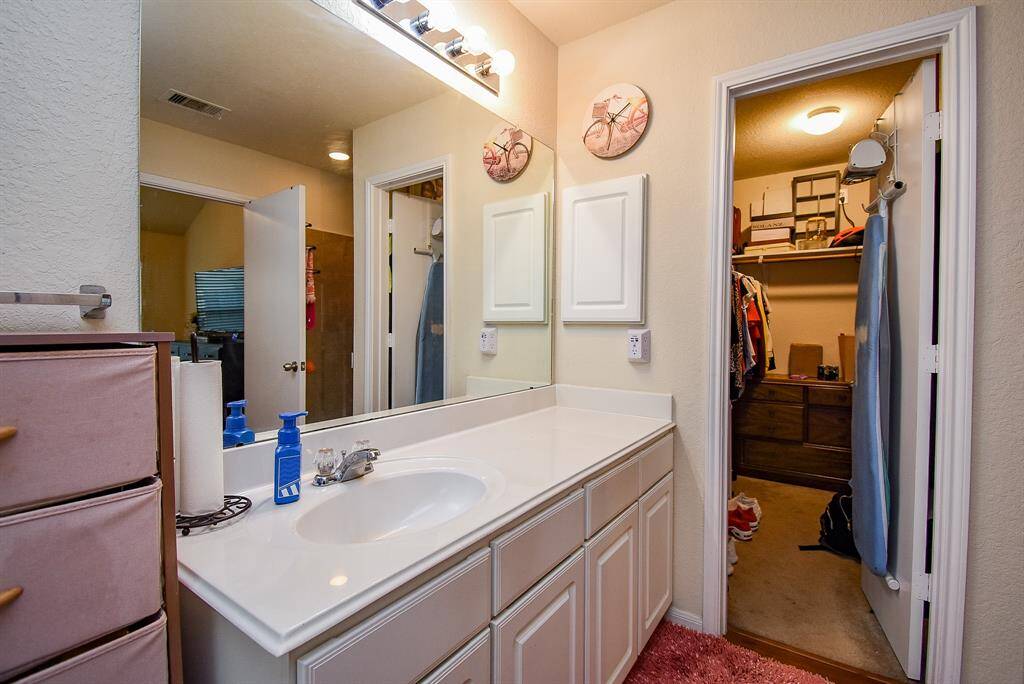 Sink with plentiful counter space; medicine cabinet. Entrance to roomy closet...