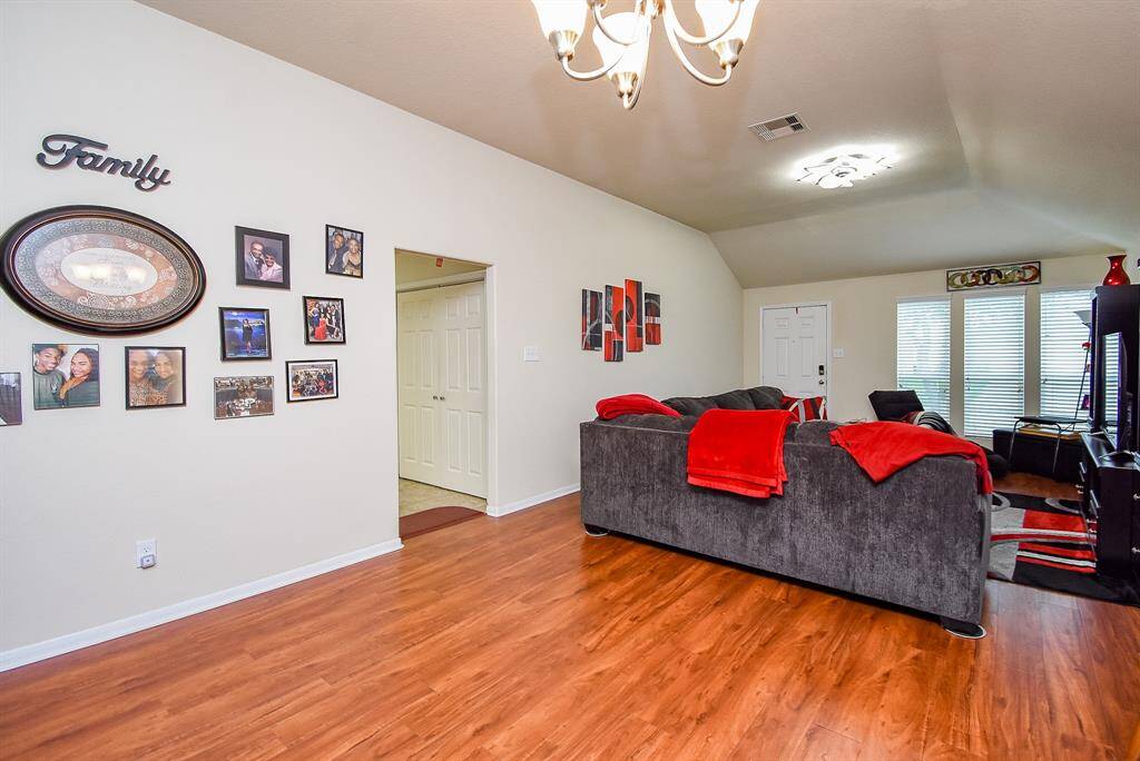 Family room view to front door & kitchen entryway