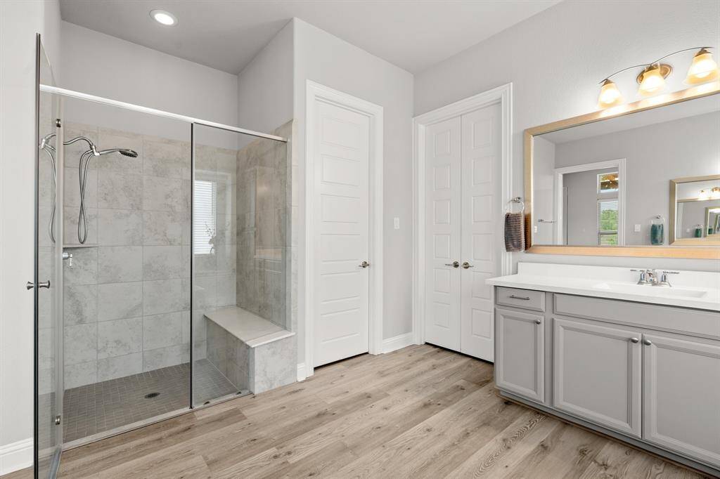 primary bath with large shower and separate vanities