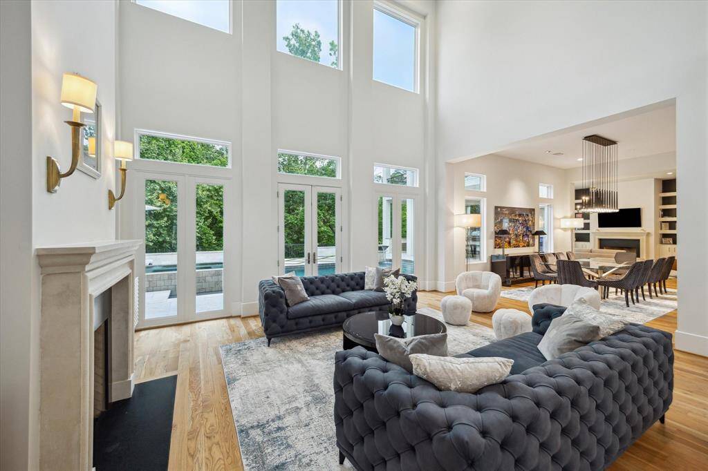 The room features a fireplace with ambient , and an open layout extending to a dining area.