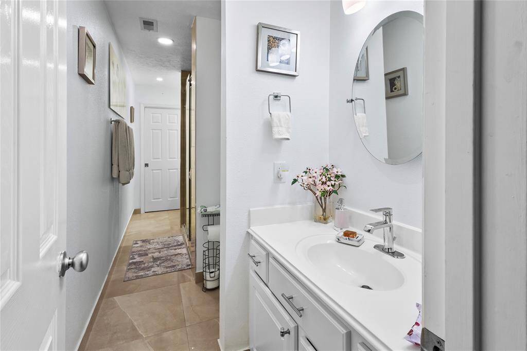 Stylish guest bathroom with a convenient double sinks on either side of the shower.
