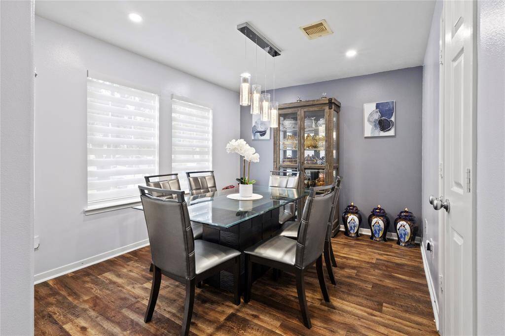 Elegant dining room featuring sleek contemporary lighting.