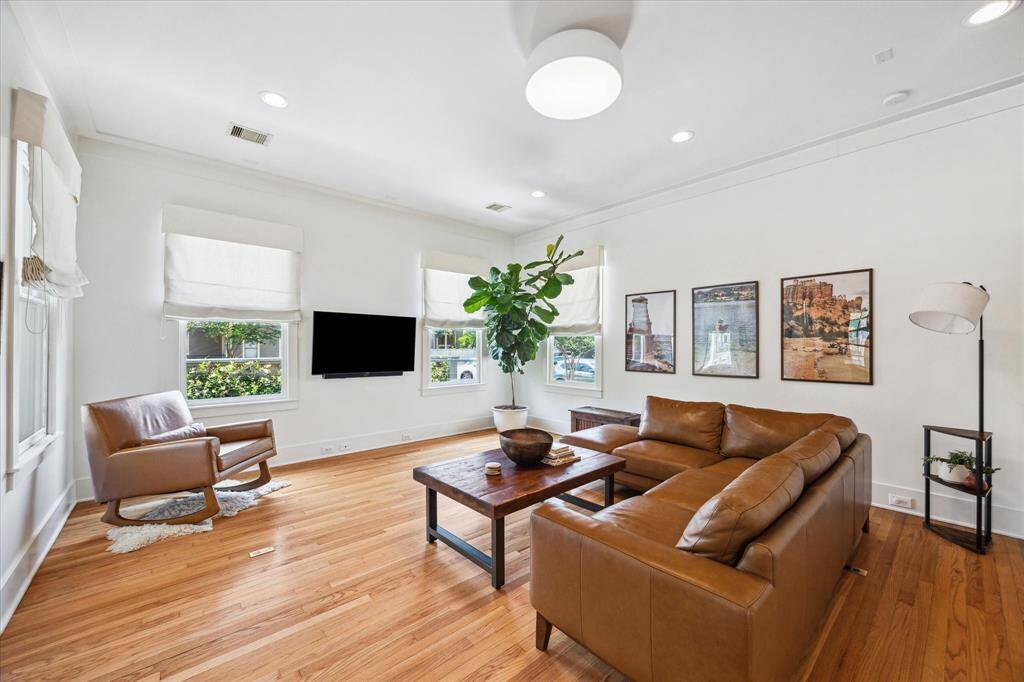 The living room offers versatility and plenty of natural light