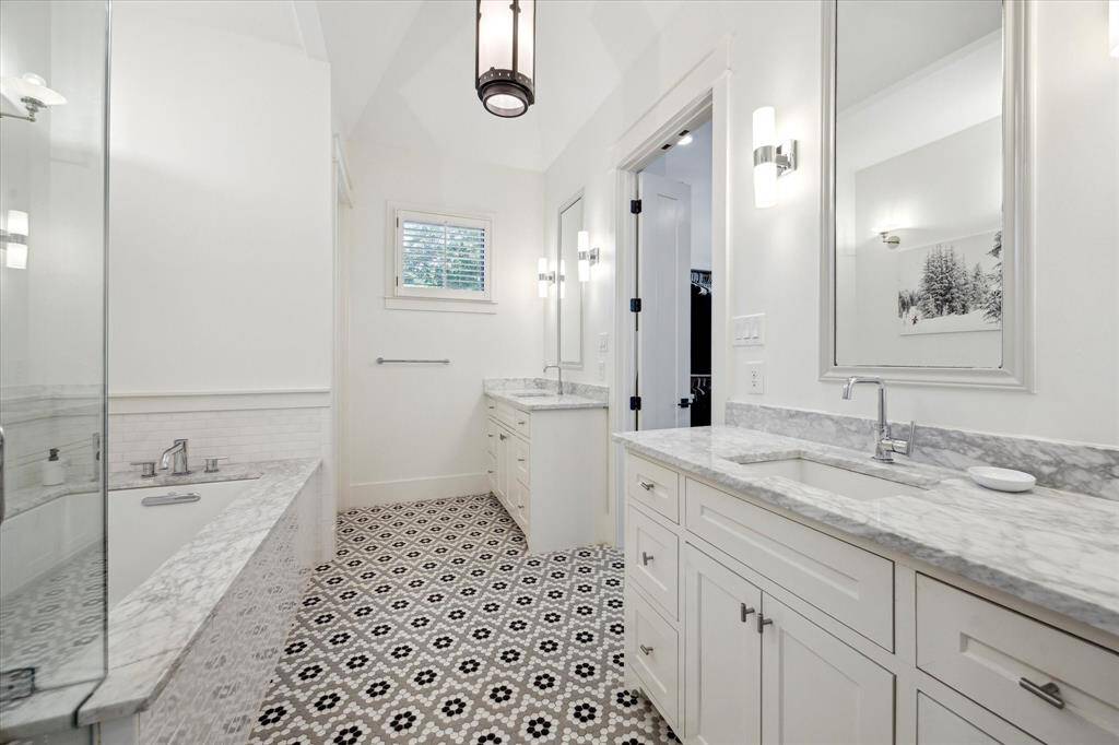 Double vanities and access to the walk-in closet with custom shelving and more built ins