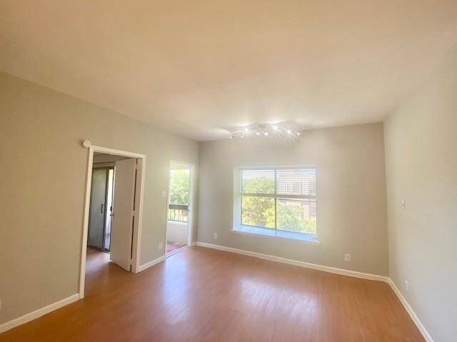Living room with door to balcony and window seat.