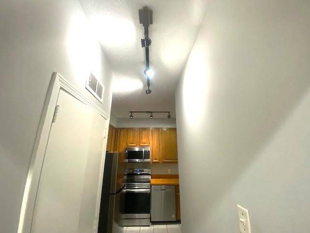 Stainless steel appliances and updated lighting.