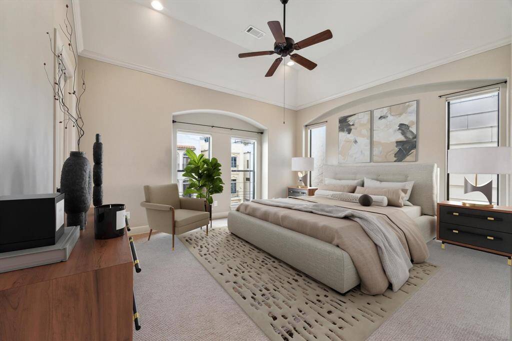 Spacious, light-filled primary suite featuring large windows, vaulted ceilings, and elegant crown molding, creating a spacious and airy retreat.