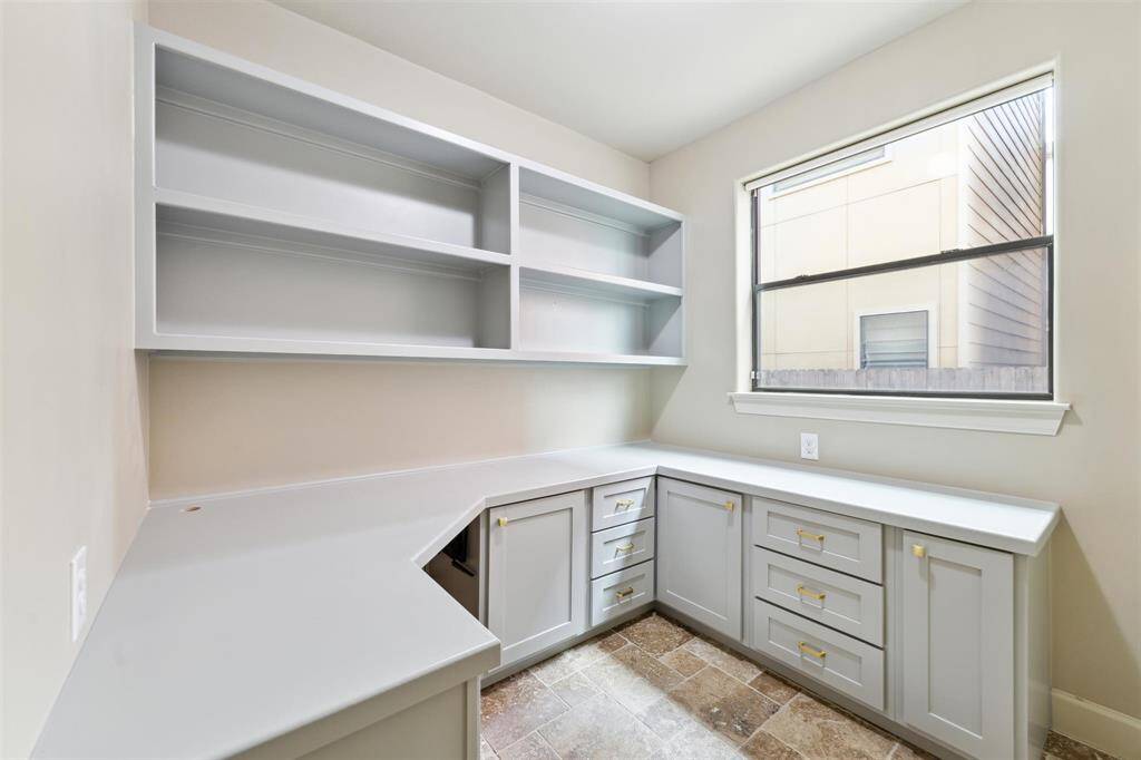 First-floor study with custom built-ins, offering ample storage and a private, quiet space — ideal for a home office or quiet retreat.