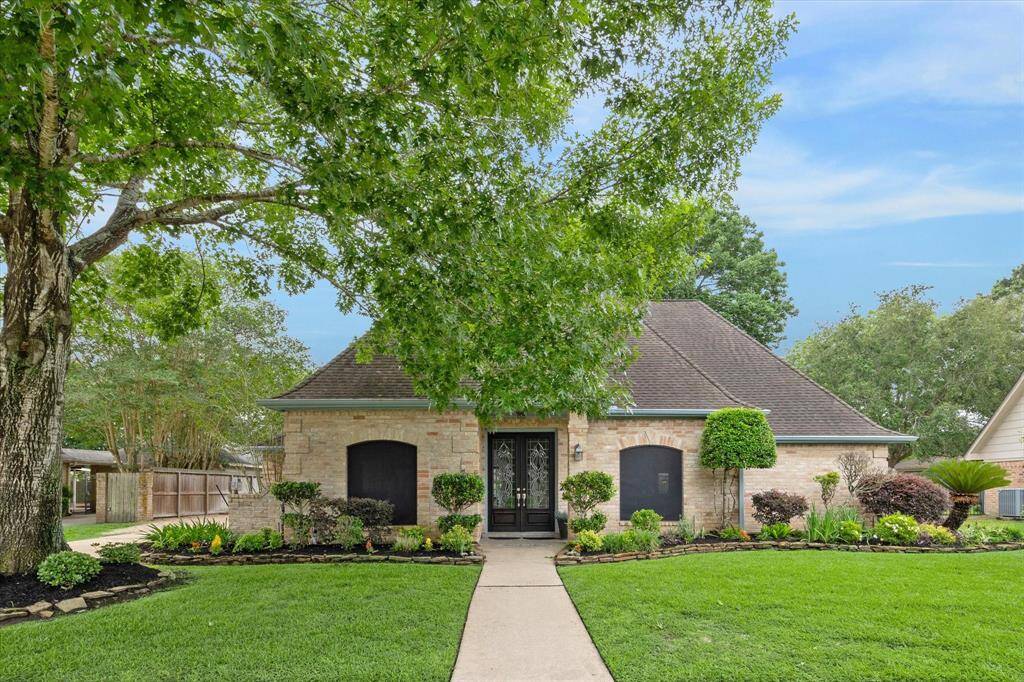 2 story brick home with solar screens, lush landscaping, water softener system, pool and more!