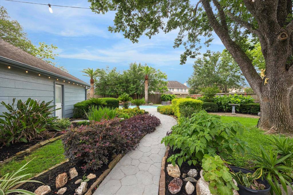 Lush landscaping welcomes you to your backyard retreat