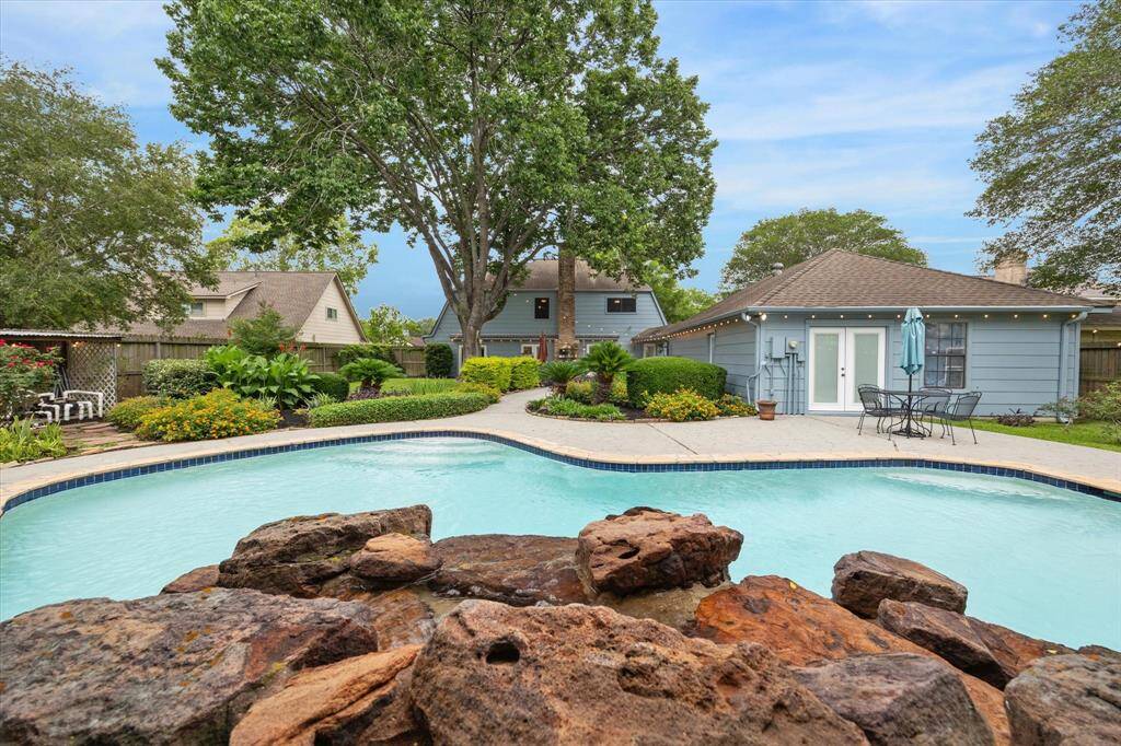 Large rock waterfall.  French doors on the right lead into a large room behind the garage.