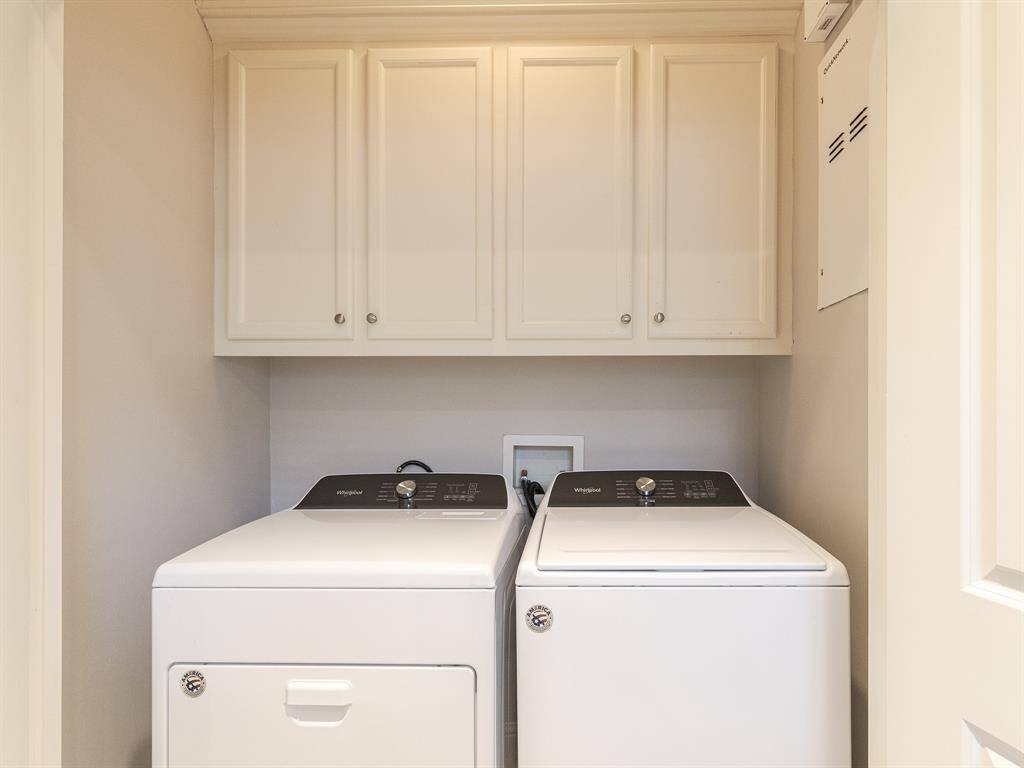 Utility room with washer dryer included
