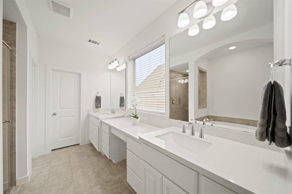 The make-up vanity with a center drawer is surrounded by additional cabinet & drawer storage.