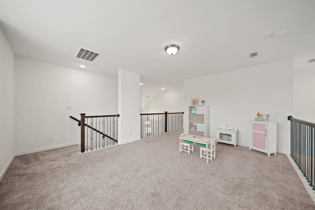 A view of the game room from the media room. The secondary bedrooms are down the hallway on the right.