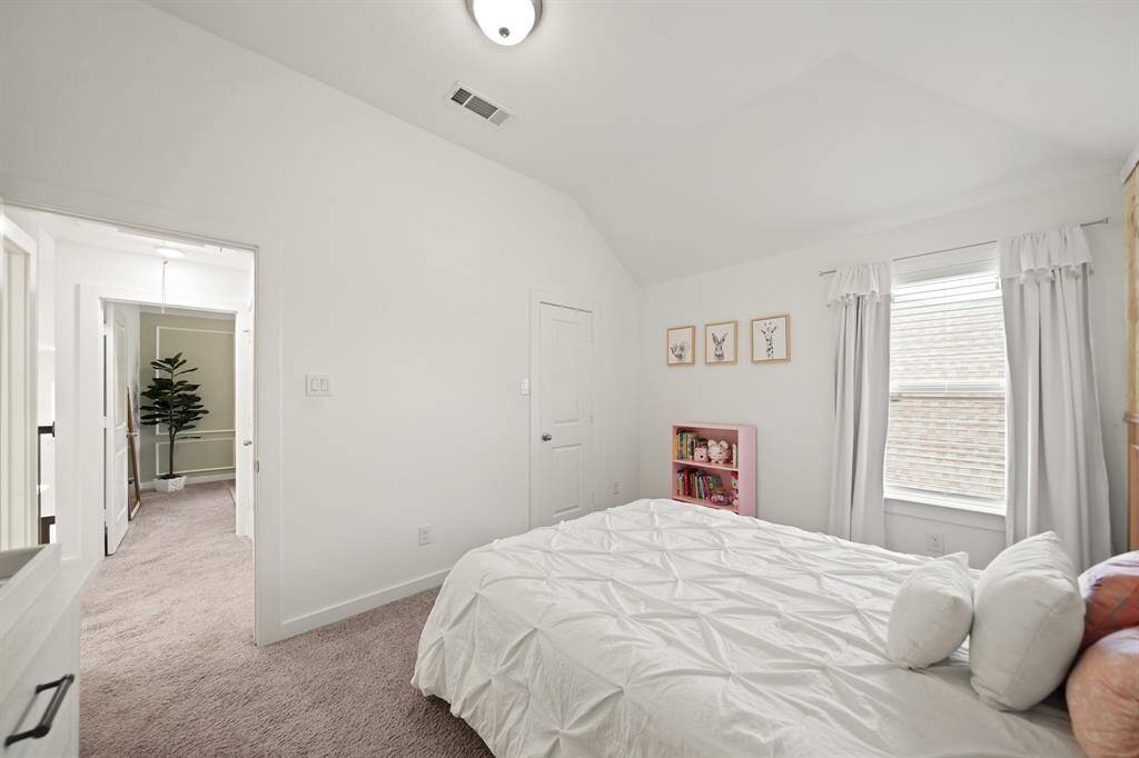 A view of the fourth bedroom with the second floor corridor in the background.