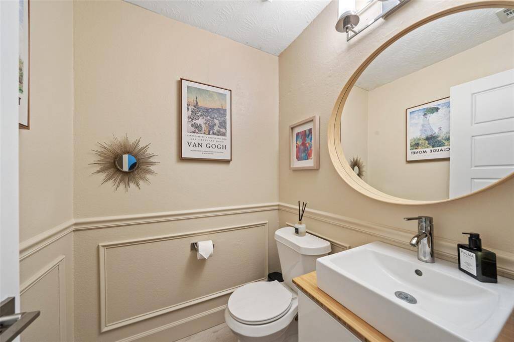 This 1/2 bathroom features a sleek, modern sink, and is off the Livingroom for convenience