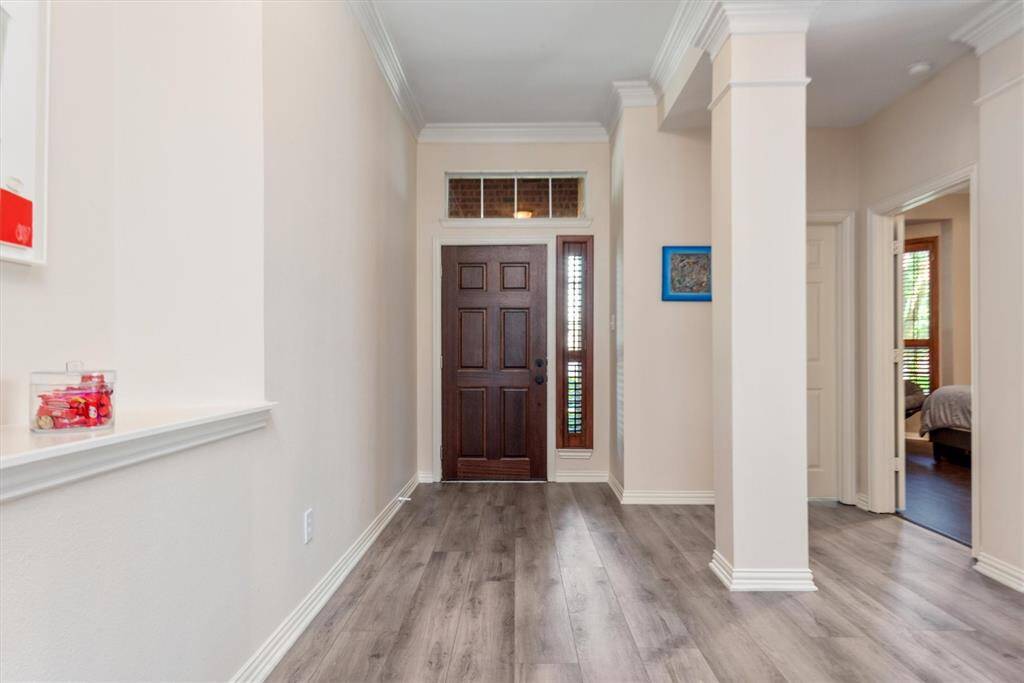 A view of the front door with the study/bedroom closest to the door and the dining room to the right.
