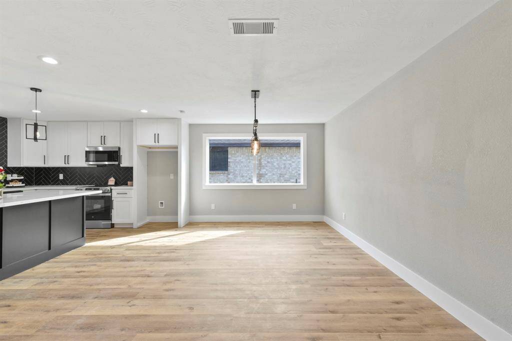 Primary Bedroom with tray ceilings and beautiful barn doors that lead to the primary retreat.