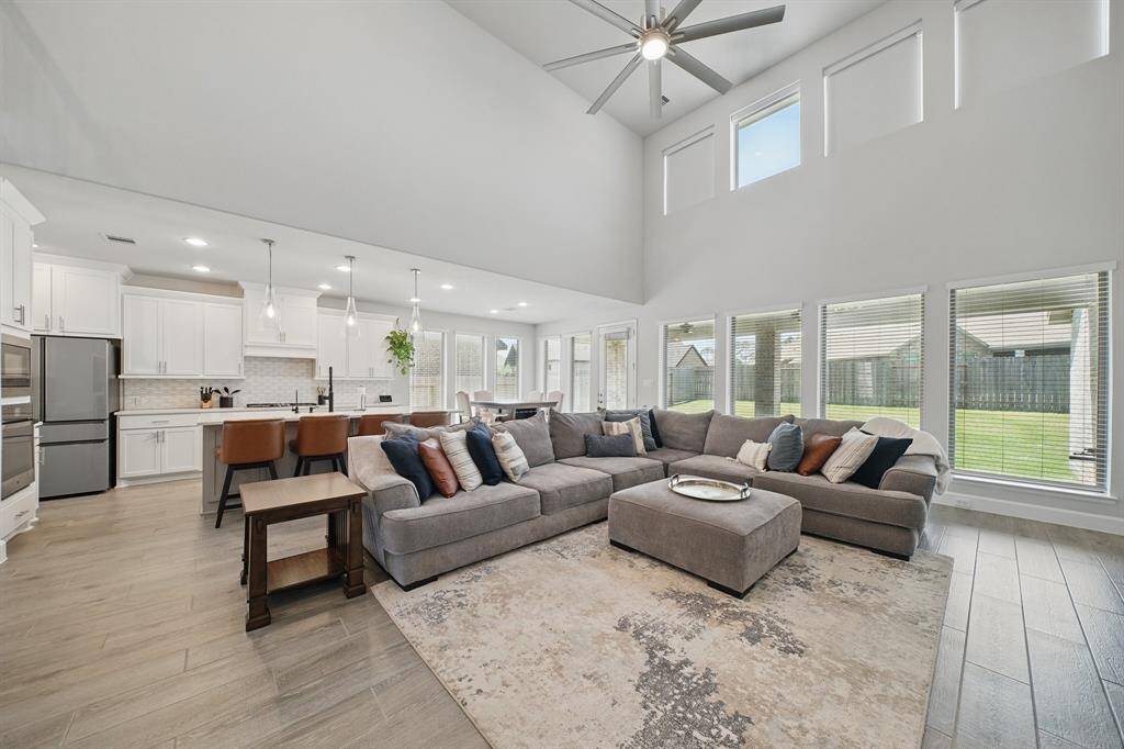 This wide-angle view highlights the seamless flow between the kitchen, dining, and living spaces, ideal for everyday living or entertaining with ease.