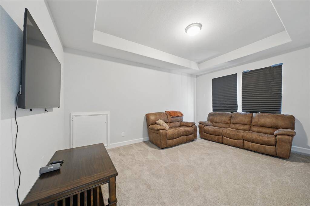 Adjacent to the game room, the media room provides a cozy, enclosed retreat ideal for movie nights or gaming, complete with blackout shades and tray ceiling.