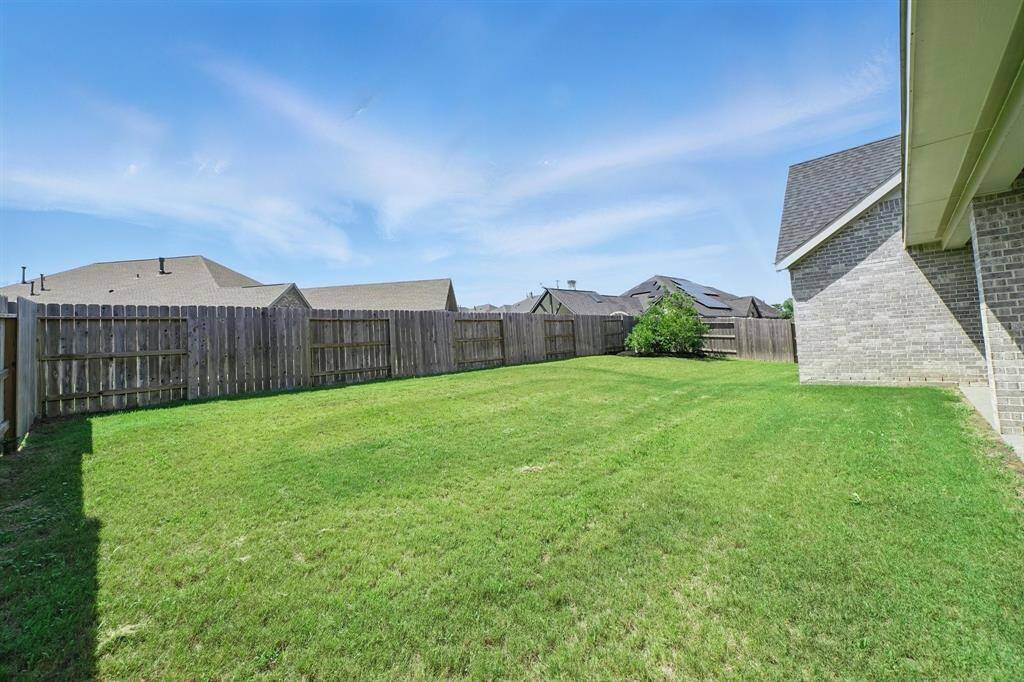 Expansive fully fenced backyard with ample green space—ideal for future pool plans, playsets, or garden customization.