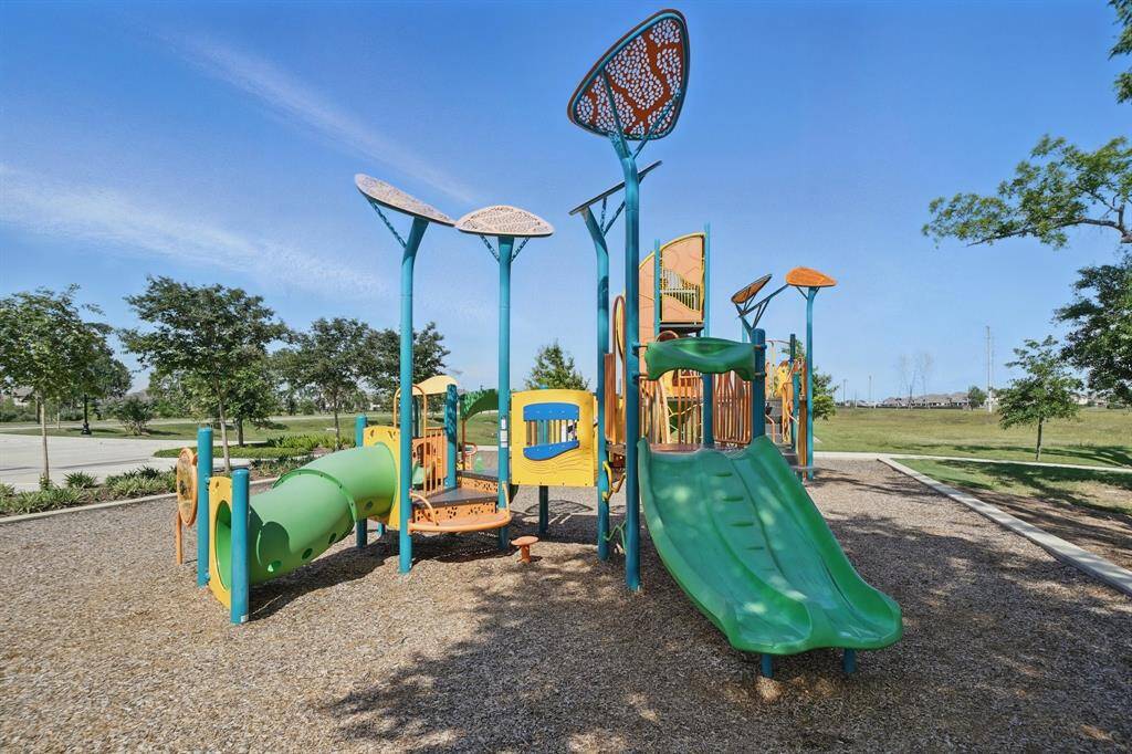 Colorful and thoughtfully designed playground with multiple climbing structures, slides, and shaded features, perfect for family fun and neighborhood playdates.