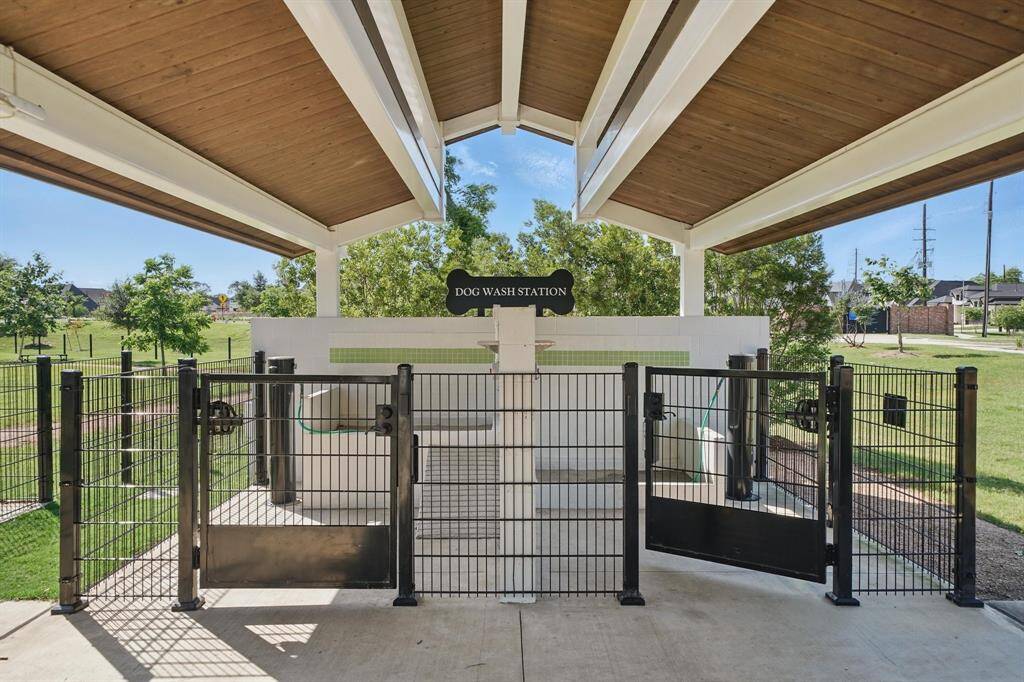 Convenient on-site dog wash station under a covered pavilion, ideal for rinsing off your furry companion after playtime.