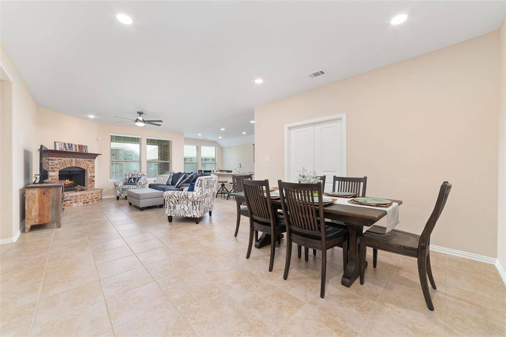 Open concept dining room with the home office/study behind the double doors.