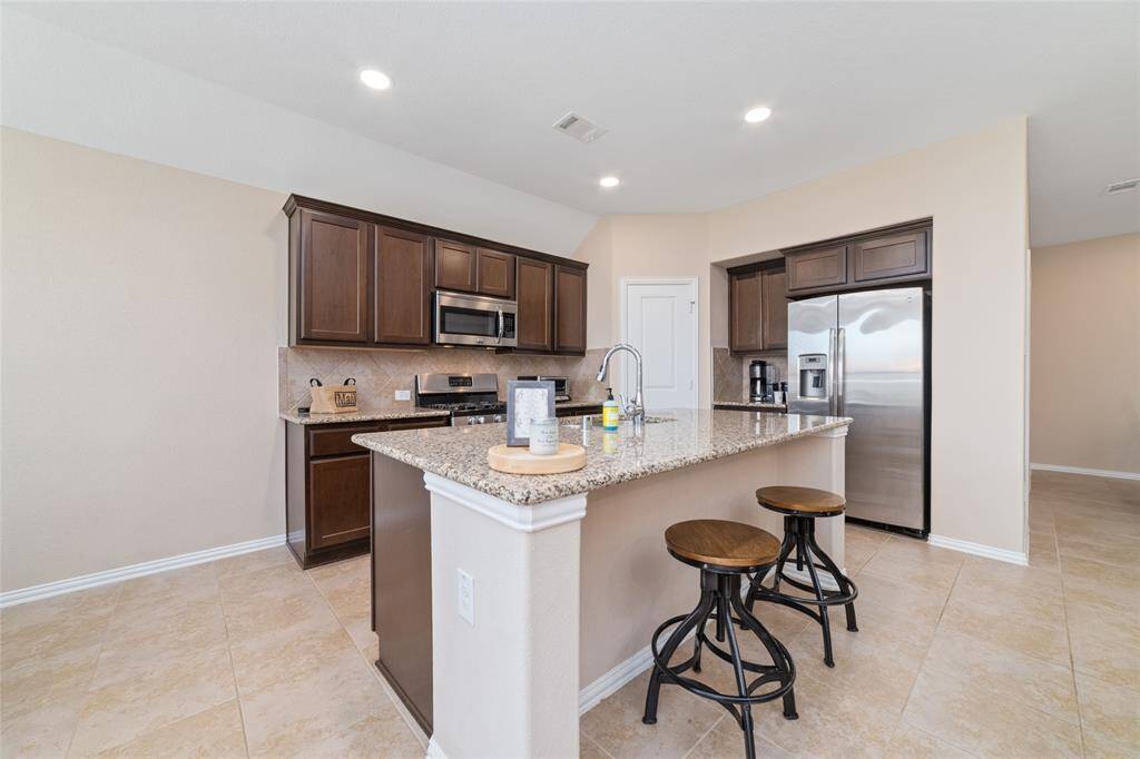 Island kitchen open to the breakfast, living, and dining room.